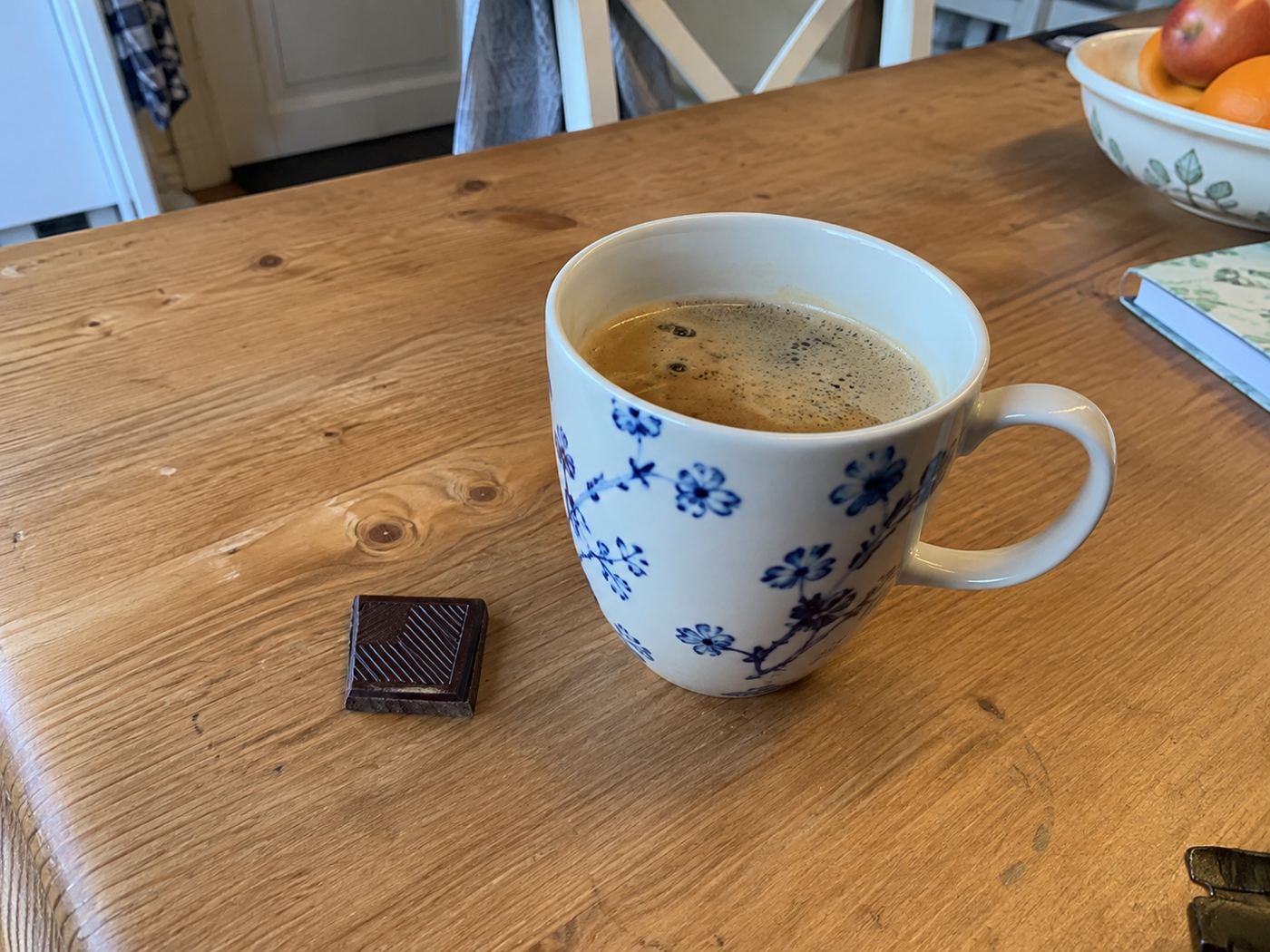 Een kop koffie met één blokje chocola